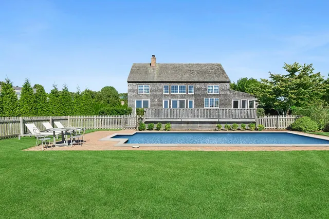 a view of a house with a yard patio and sitting area