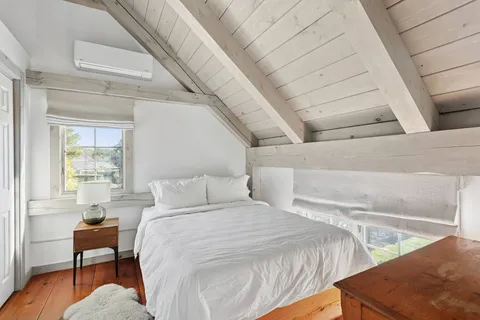 a bedroom with a bed and a lounge chair