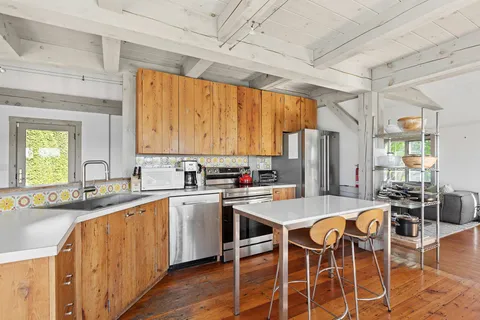 a kitchen with appliances a sink and cabinets