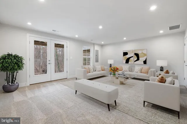 a living room with furniture and potted plants