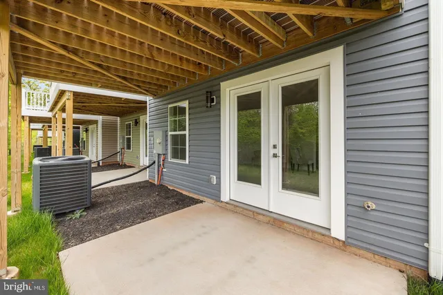 a view of a porch with wooden floor and iron stairs