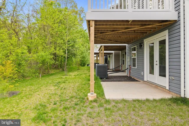a view of a patio with table and chairs and potted plants
