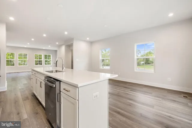 an open kitchen with a sink and dish washer