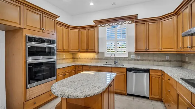 a view of a livingroom with wooden floor and a ceiling fan