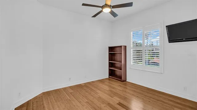a view of a hallway with a window and a bathroom