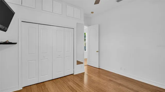 an empty room with windows and closet