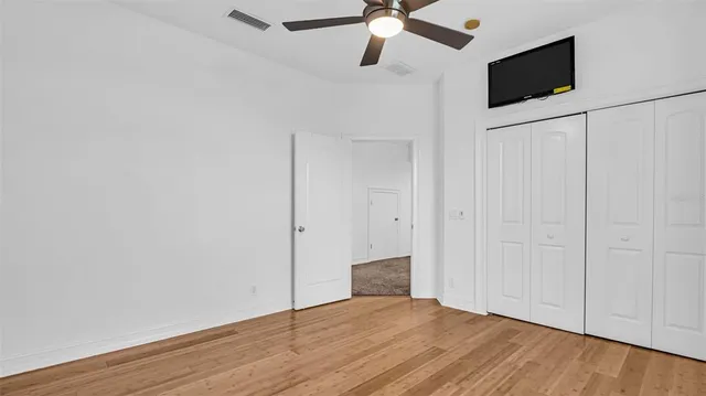 a view of a room with wooden floor and staircase
