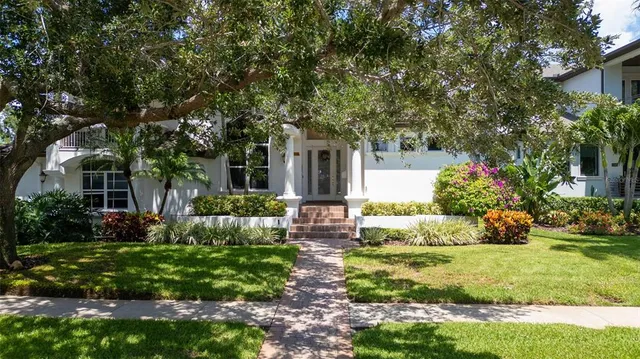 a front view of a house with a garden