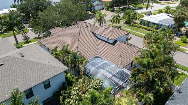 an aerial view of a house with a yard and lake view