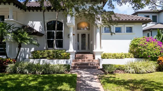 an aerial view of a houses with yard