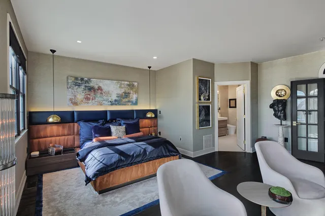 a bedroom with furniture and a large window