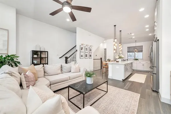 a living room with furniture and kitchen view