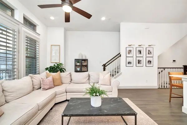 a living room with furniture potted plant and a chandelier