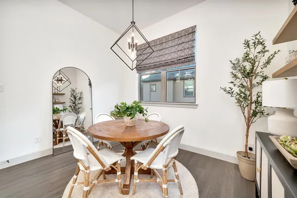 a large white kitchen with sink a counter top space and stainless steel appliances