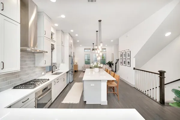 a very nice looking living room with a large window and stainless steel appliances