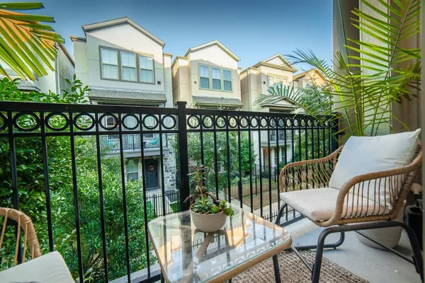 a view of a chair and table in the balcony