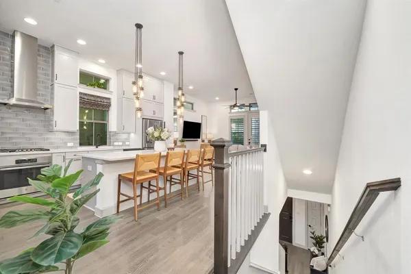 a very nice looking dining room with a large window and wooden floor