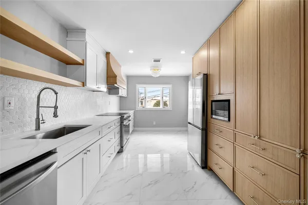 a kitchen with granite countertop a sink and refrigerator