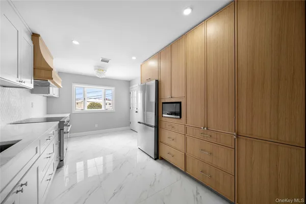 a kitchen with granite countertop white cabinets and white appliances