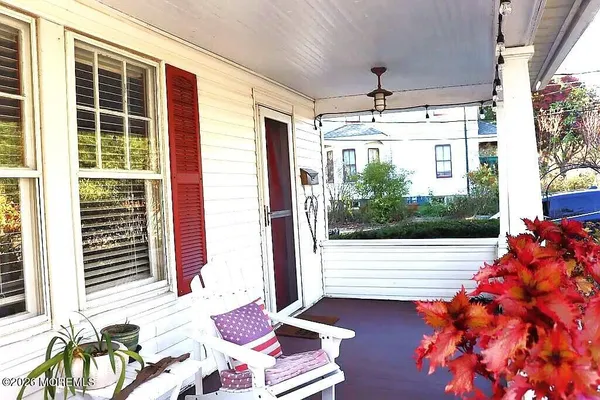 a view of a porch with furniture and garden