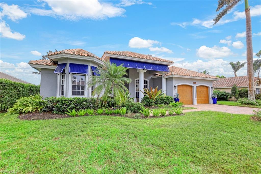 7235 Mill Run Road Naples, FL 34109 - Photo 12 of 31 a front view of a house with garden