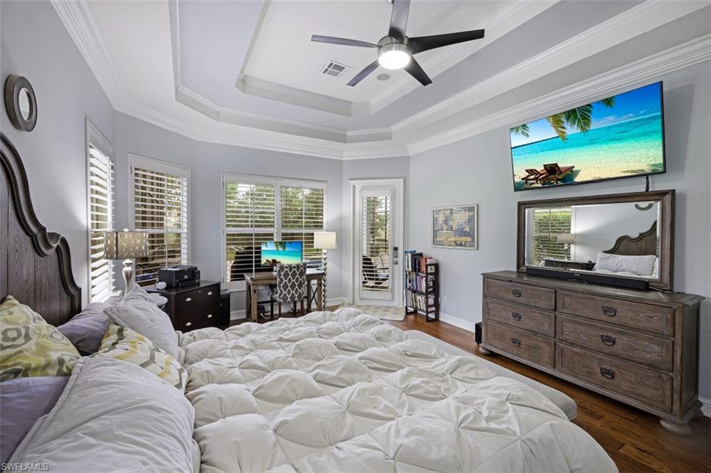 7235 Mill Run Road Naples, FL 34109 - Photo 19 of 31 a large bedroom with a bed and large mirror