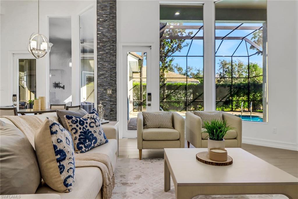 7235 Mill Run Road Naples, FL 34109 - Photo 2 of 31 a bedroom with furniture and a large window