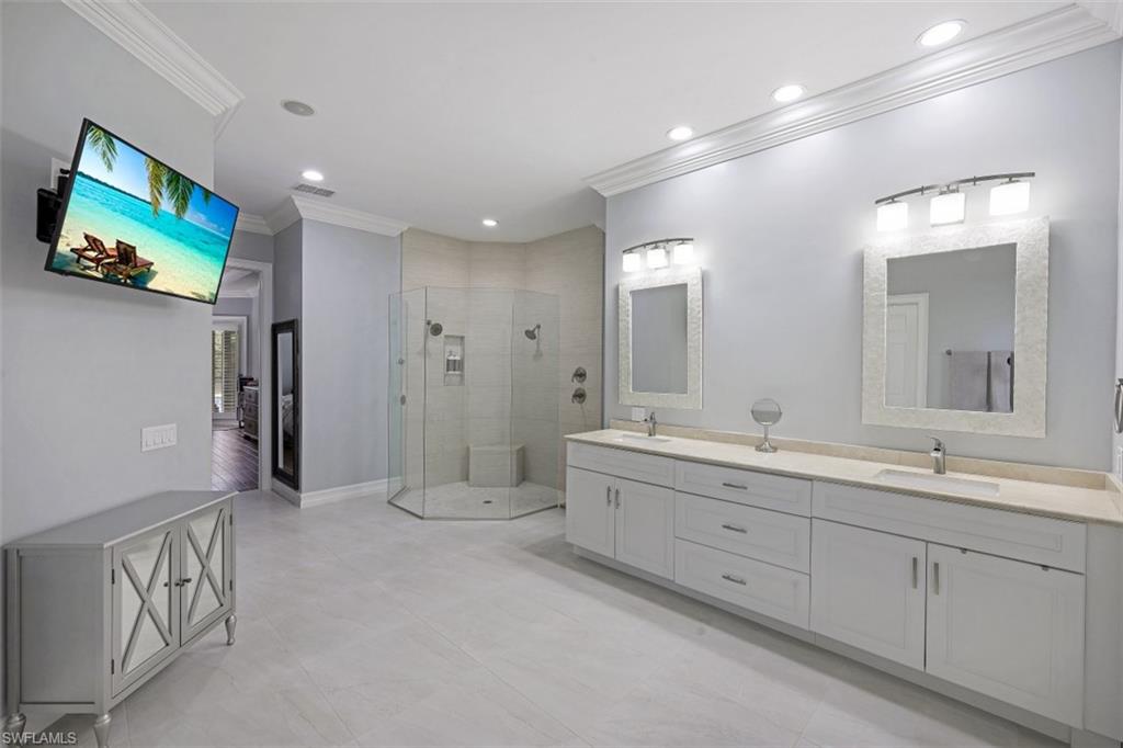 7235 Mill Run Road Naples, FL 34109 - Photo 21 of 31 a large bathroom with a double vanity sink and a mirror