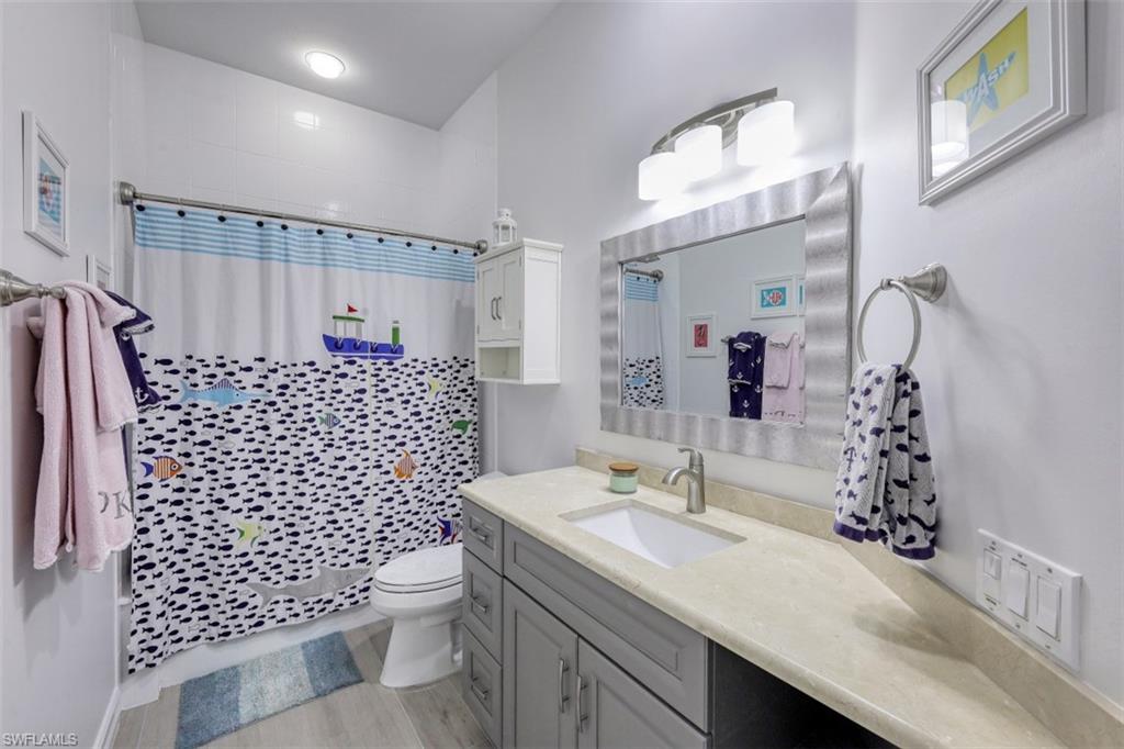 7235 Mill Run Road Naples, FL 34109 - Photo 23 of 31 a bathroom with a sink a toilet and shower