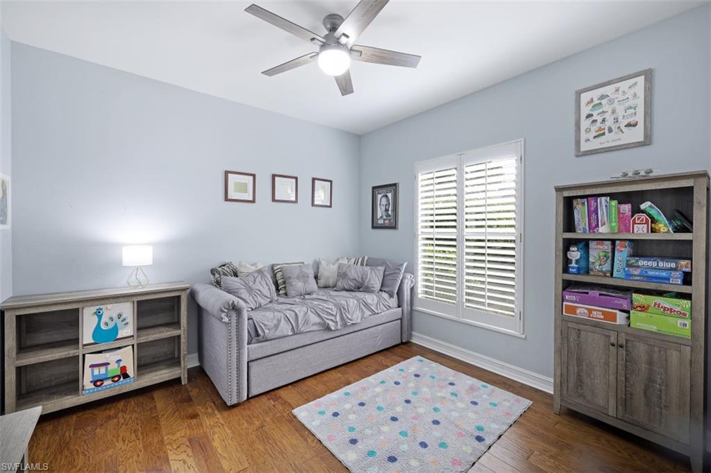 7235 Mill Run Road Naples, FL 34109 - Photo 24 of 31 a living room with furniture and a window