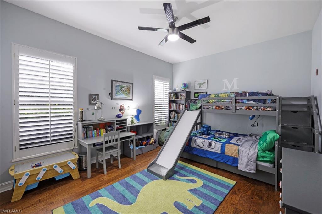 7235 Mill Run Road Naples, FL 34109 - Photo 25 of 31 a bed room with furniture and wooden floor