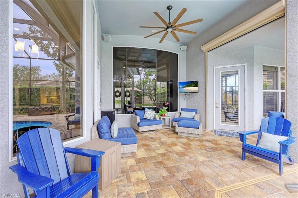 7235 Mill Run Road Naples, FL 34109 - Photo 27 of 31 a living room with furniture and a large window
