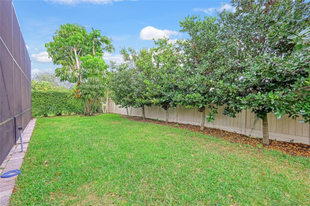 7235 Mill Run Road Naples, FL 34109 - Photo 31 of 31 a backyard of a house with lots of green space