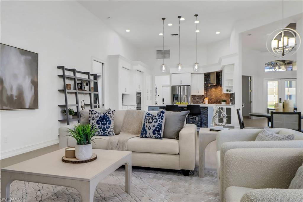 7235 Mill Run Road Naples, FL 34109 - Photo 4 of 31 a living room with furniture kitchen and a potted plant