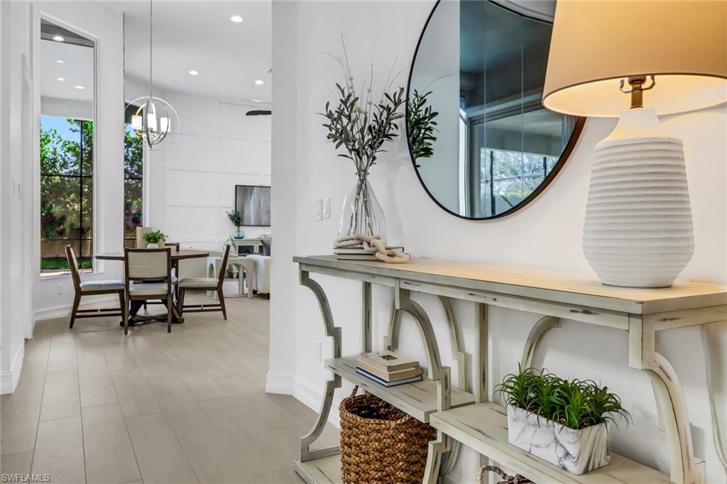 7235 Mill Run Road Naples, FL 34109 - Photo 5 of 31 wooden floor with a table and chairs in it