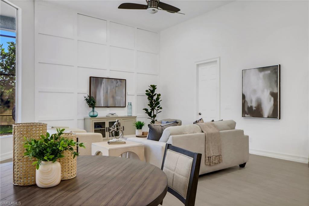 7235 Mill Run Road Naples, FL 34109 - Photo 6 of 31 a living room with furniture potted plant and mirror