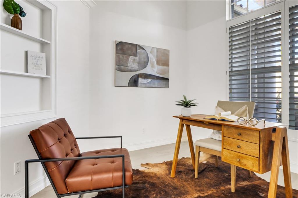7235 Mill Run Road Naples, FL 34109 - Photo 7 of 31 a view of a workspace room with furniture and wooden floor