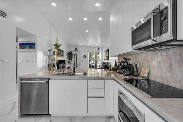 a kitchen with a sink stainless steel appliances and cabinets