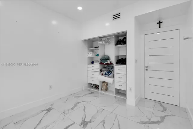 a view of a bedroom with a furniture and closet