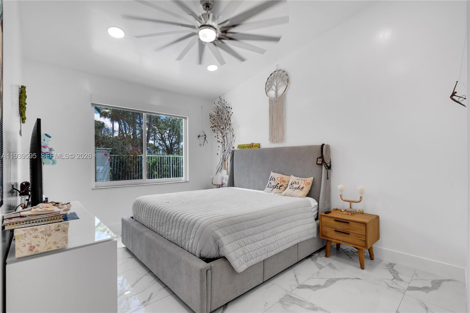 18801 Southwest 25th Court Miramar, FL 33029 - Photo 20 of 28 a bedroom with a bed and a chandelier
