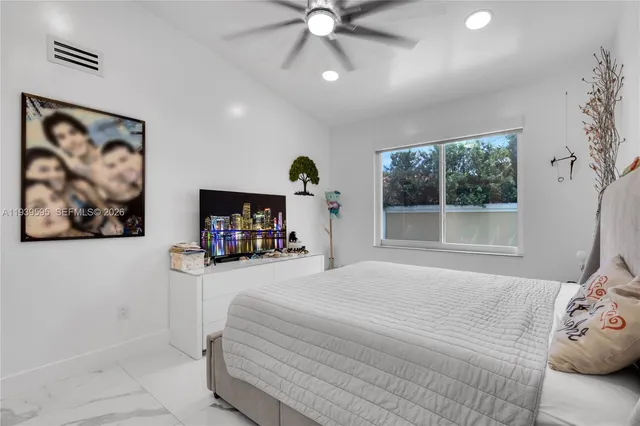 a bedroom with a bed and a painting on the wall