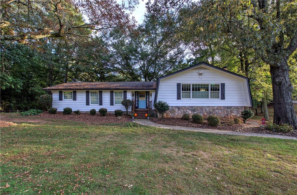 1240 Evans Cook Road Canton, GA 30115 - Photo 1 of 1 a front view of a house with yard and green space