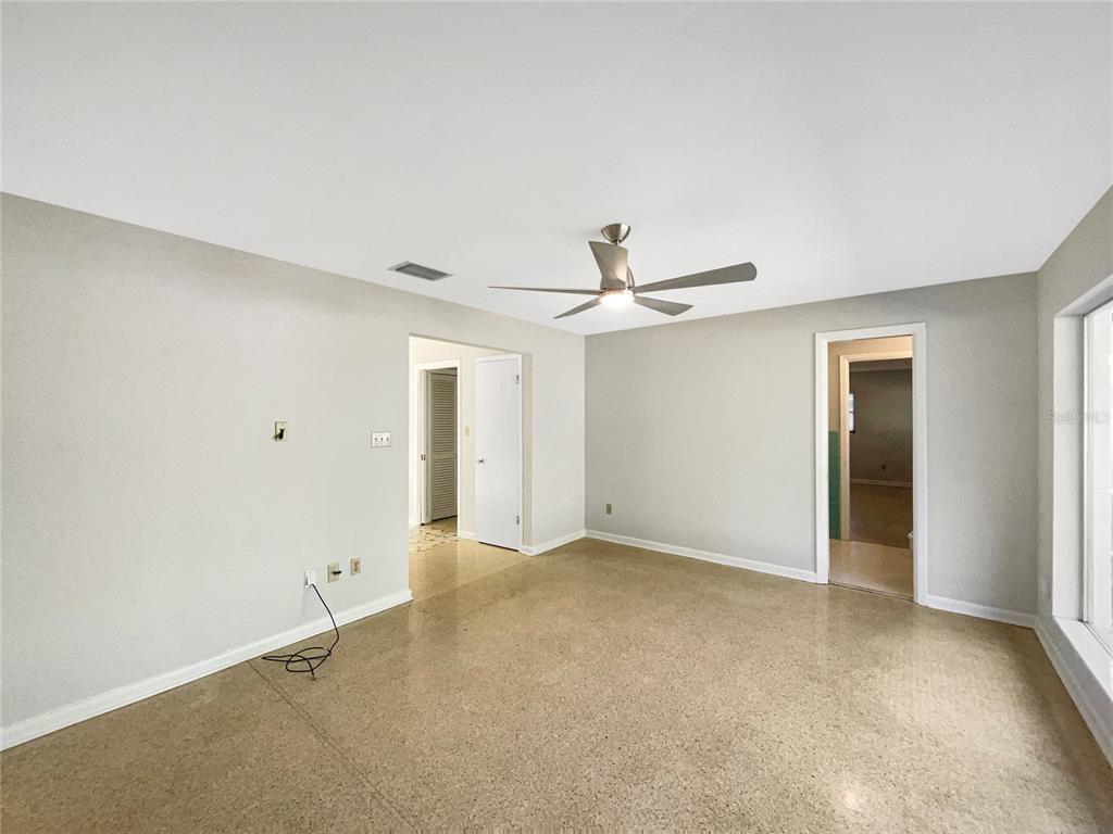 5250 Timberlane Road Lake Wales, FL 33898 - Photo 12 of 23 an empty room with a ceiling fan and a window