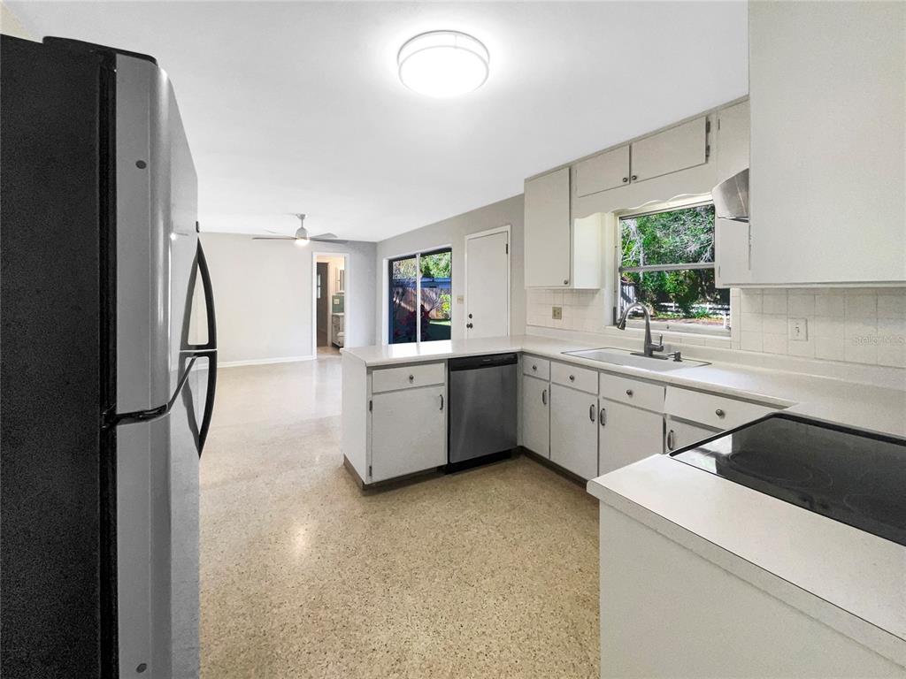 5250 Timberlane Road Lake Wales, FL 33898 - Photo 13 of 23 a kitchen with a sink a refrigerator and cabinets