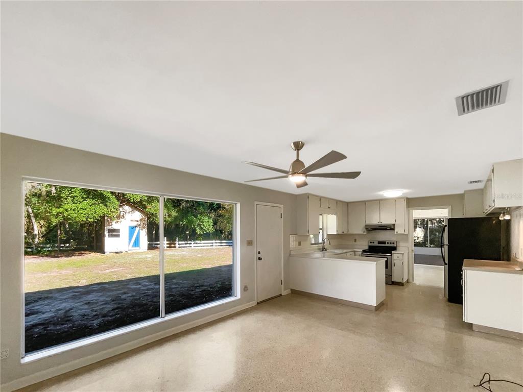 5250 Timberlane Road Lake Wales, FL 33898 - Photo 7 of 23 a open kitchen with kitchen island a large counter top space a refrigerator and stainless steel appliances