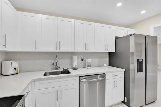 a living room with furniture a flat screen tv and a window