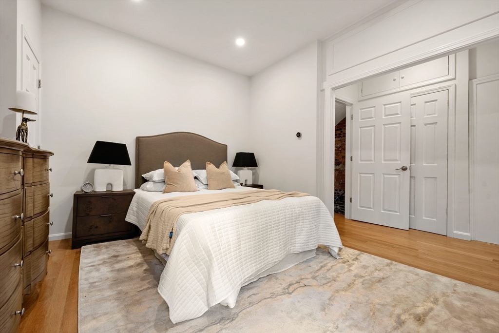 18 Melrose Street, Unit 1 Boston, MA 02116 - Photo 12 of 24 a bedroom with a bed and wooden floor