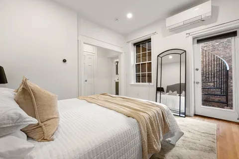 a bedroom with a bed and a dresser