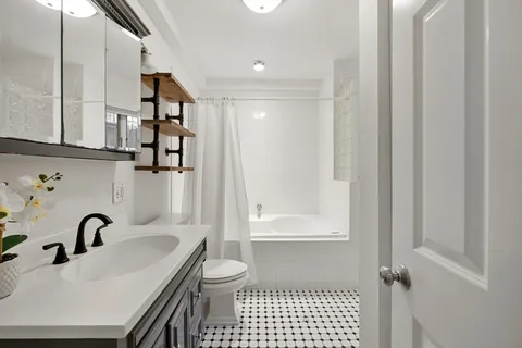 a bathroom with a sink toilet and shower