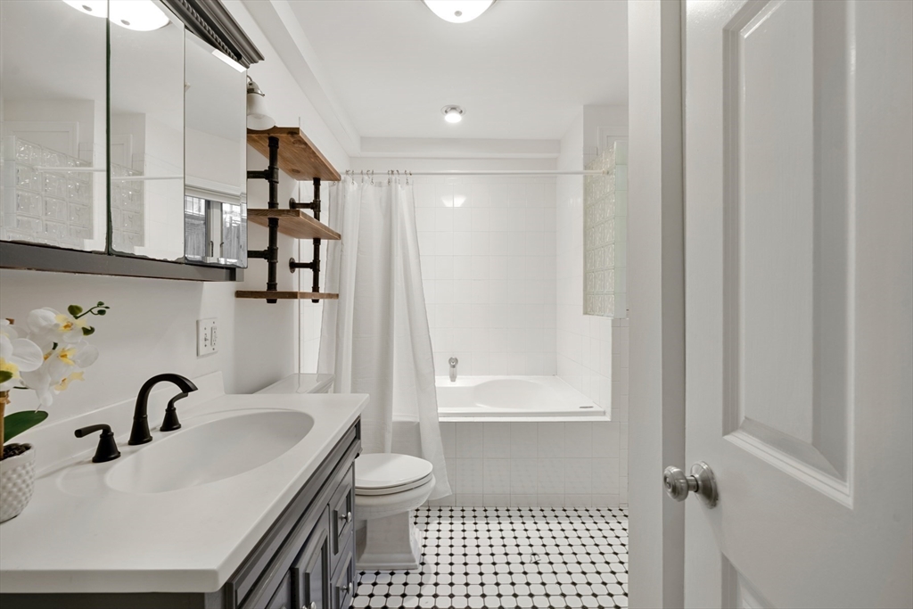 18 Melrose Street, Unit 1 Boston, MA 02116 - Photo 14 of 24 a bathroom with a sink toilet and shower